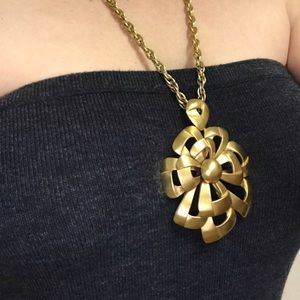 $65 Gold necklace with flower detail.